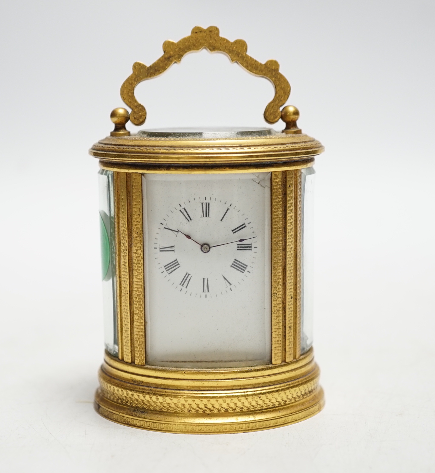 A late 19th French miniature engraved oval cased carriage timepiece, height 7cm